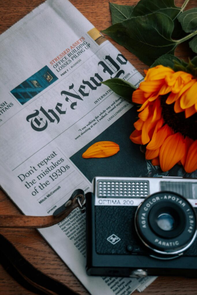 Decorative image showing a NY Times newspaper and camera